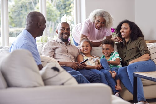 multi-generation-family-sitting-on-sofa-in-lounge-2023-11-27-04-53-24-utc