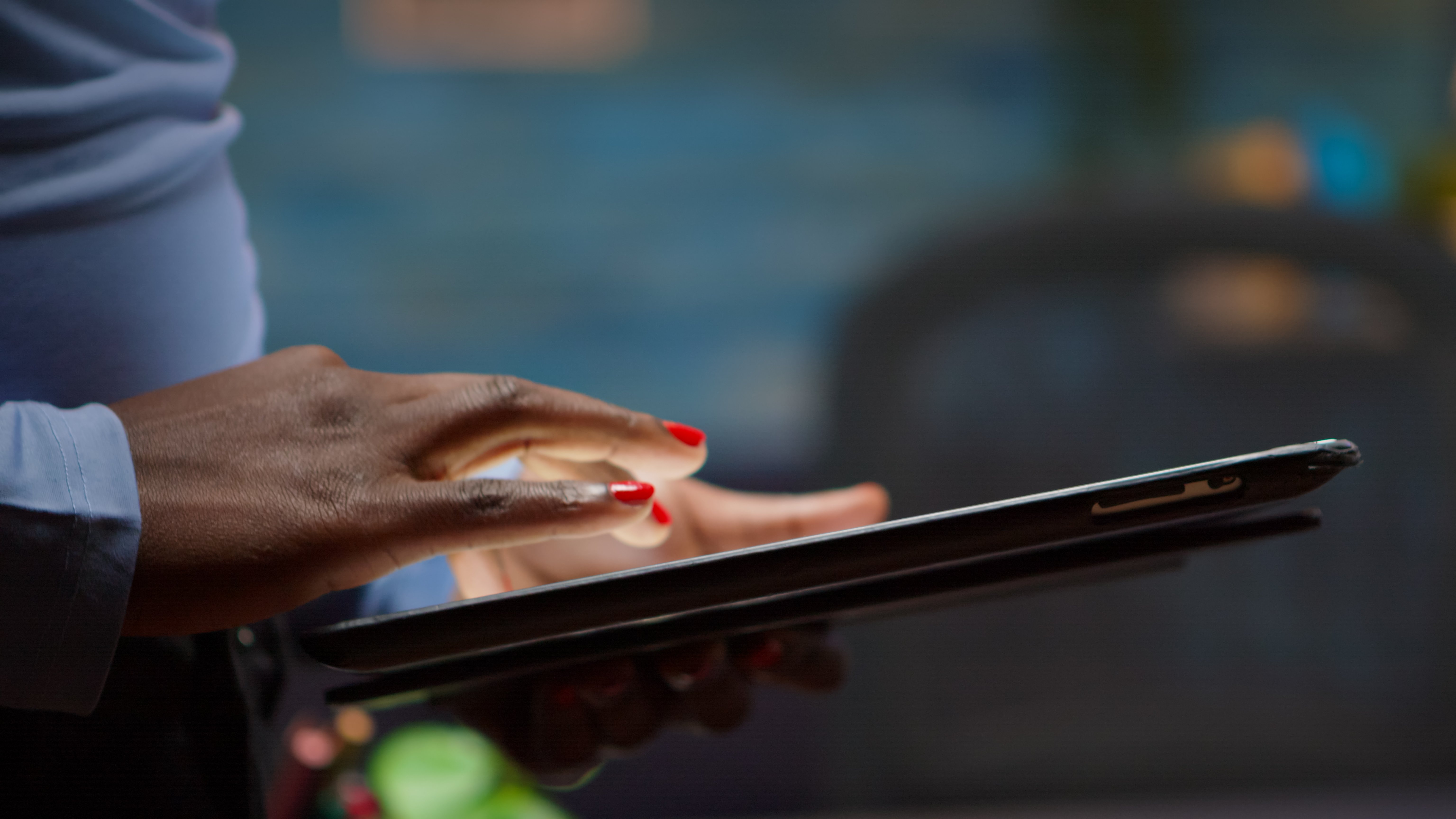 african-employee-using-tablet-standing-in-living-r-2023-11-27-05-37-09-utc